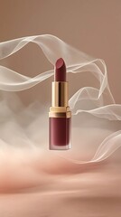 Image of lipstick tube floating above soft mist surrounded by silky thin veils of ribbons, product presentation.