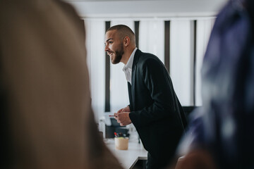 A professional individual in a business setting interacts dynamically during a collaborative meeting with colleagues.