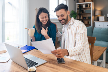 Obraz premium Finance and economy. Young couple, small business owners, working online at home office, preparing for video call for presentation and online coaching. E-commerce man and woman professional occupation