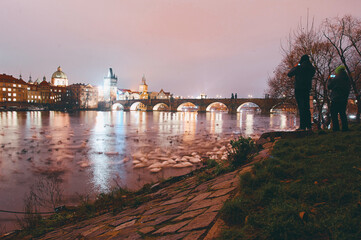 Two Photographers Capturing the Iconic Charles Bridge at Night