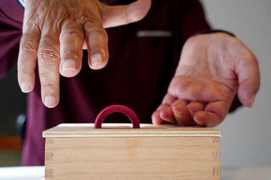 ALS person hands using cognitive therapy tools at home