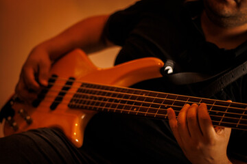 Músico tocando contrabaixo elétrico em estúdio de gravação / Musician playing electric bass guitar in recording studio