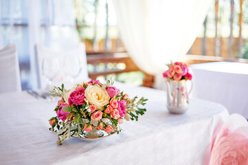 Elegant Floral Arrangement on a Wedding Table in Brightly Lit Setting