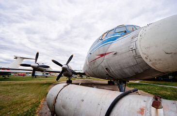 A vintage IL-18 airplane exhibited outdoors in an aviation museum, showcasing its propeller and...
