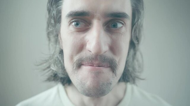 Comedic European Comical Funny weird Man with Long Hair and Mustache Expresses Joy and Amusement