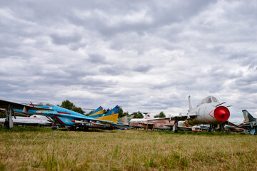 Row of Retired Military Aircraft Under a Cloudy Sky