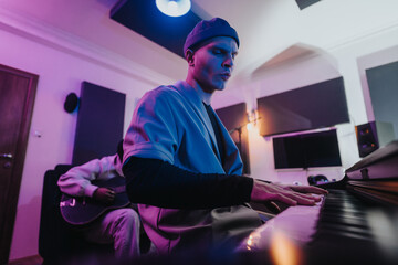 Two musicians play instruments passionately in a contemporary music studio. The setting reflects...