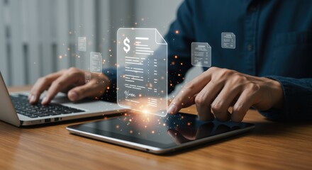A digital invoice floats above a businessmans hands as he works on a laptop and tablet, illuminated by a soft glow