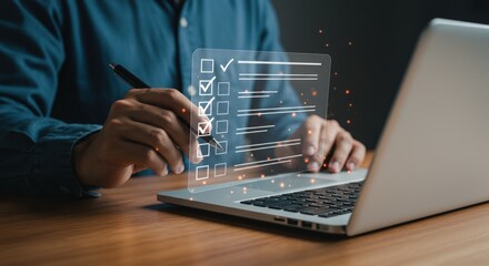 Person using a pen to complete a digital checklist on a laptop computer on a wooden table