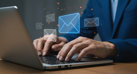 Hands typing on a laptop with email icons floating above the keyboard