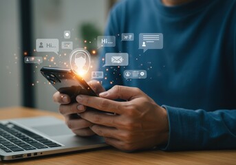 Man uses his smartphone to communicate and connect with others through social media and online messaging while working on his laptop