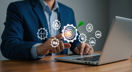 Businessman points to a target with a green arrow surrounded by sustainability icons on a laptop screen