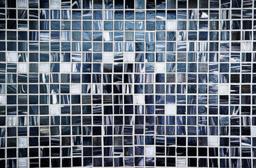 Detailed close-up view of an abstract mosaic composition featuring black and white tiles arranged...