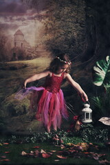 A young girl dressed as a fairy, holding a lantern, in a forest setting.
