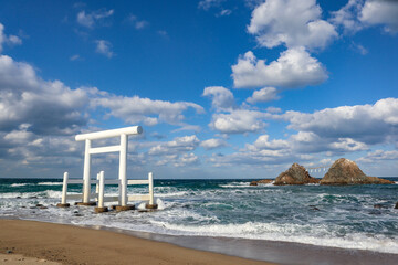White Torii Gate and Meoto Iwa Couple Rocks in Itoshima, Japan