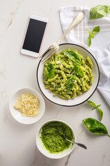 Pasta with pesto sauce and basil