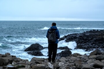 Person exploring Giant's Causeway, Ana of Hexagonal Basalt Stones, Created by Ancient Volcanic...