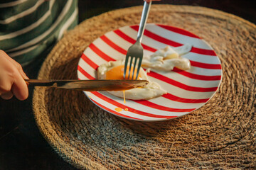 Young European Boy Eating Fried Egg at Breakfast