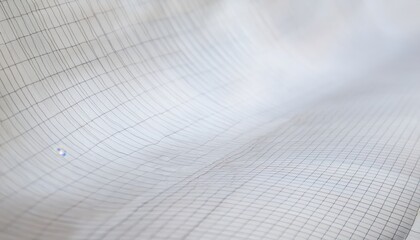 curved close-up of white graph paper with fine blue grid lines and glossy surface reflection, ideal for web design, branding element, or geometric background texture

