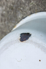 enameled basin bottom with chipped enamel closeup