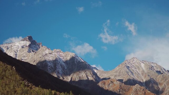 Clouds above the dried Himalayan mountain peaks during the summer season as seen from Chitkul village in Kinnaur district, Himachal Pradesh, India. Scenic view of Himalayas in summer season.
