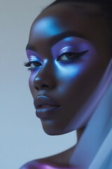 Close-up of a black woman's face with metallic blue eye makeup with blur effect.