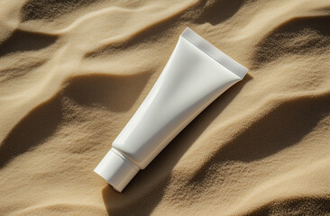 High-res mockup of an empty white plastic body cream tube lying on smooth sand. Close-up, top view, flat lay style with fine, detailed texture—isolated object with a clean stock photo effect.