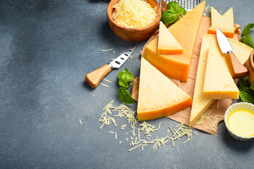Assortment of aged hard cheeses. Set of cheese slices. Side view.