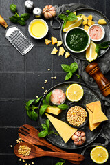 Homemade traditional pesto sauce and ingredients. Top view.