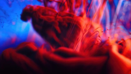 Fototapeta premium vibrant red ink swirling in blue liquid abstract background for web design, print media, and branding with fluid motion and dramatic color contrast