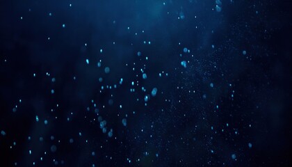 Obraz premium dark blue underwater particles floating in motion blur with glowing bokeh effect and dreamy depth for website background, print poster, or branding texture