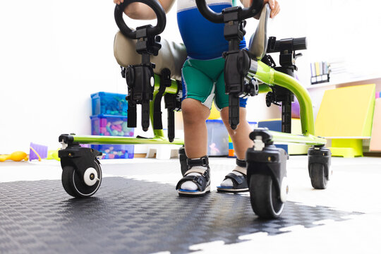 Walker for rehabilitation and restoration of walking of child in rehabilitation center, close-up . Mobility aids in pediatric physiotherapy