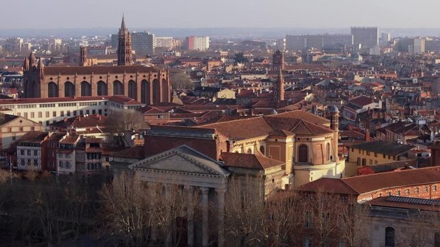 Urban landscape of Toulouse city center at sunset, featuring Notre Dame de la Daurade and Couvent des Jacobins and other landmarks