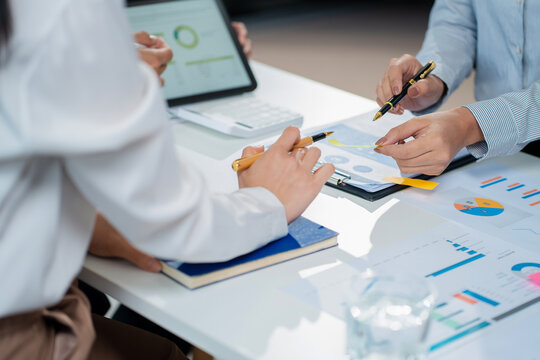 financial asian advisor showing plan of investment to clients in the consultancy office. - Powered by Adobe