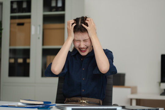 Stressed female programmer facing frustration at work in office.