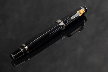 Branded pen in a box. Gift set. Selective focus. Office interior.
