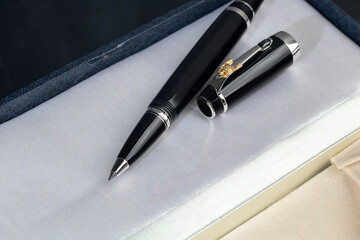 Branded pen in a box. Gift set. Selective focus. Office interior.