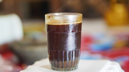 beautiful video of a cup of black coffee in a white glass
