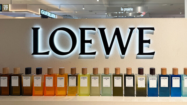 Row of vividly hued Loewe perfume bottles evokes olfactory opulence, festive Olentzero whispers with aromatic elegance April 5, 2025, Zaragoza, Spain