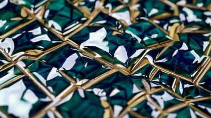 Emerald green and gold tiles, reflecting light and creating an elegant mosaic pattern, are perfect for luxurious interior design projects seeking a touch of opulence and sophistication