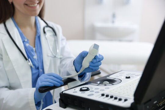 Professional sonographer with ultrasound machine in clinic, closeup