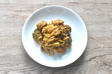 spicy stir fried bamboo shoot and chicken with curry on plate