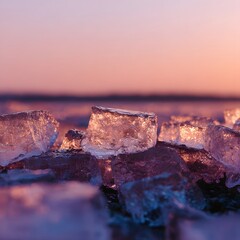 Ice cubes glistening at sunset on a lakeshore, creating a serene atmosphere with soft colors