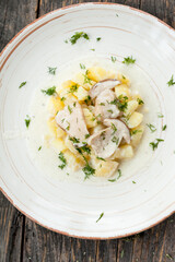 Potatoes with porcini mushrooms and dill on a plate