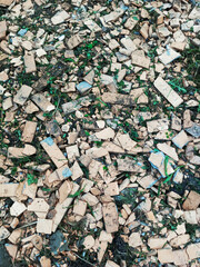 Broken beige plaster stones trimmings on the ground. Background texture.
