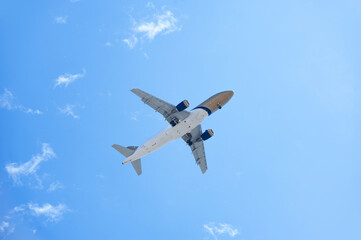 XL jet airplane landing in bright sky