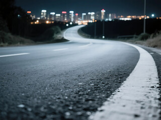 Obraz premium closeup asphalt winding road leading into the city at night. Selective focus.