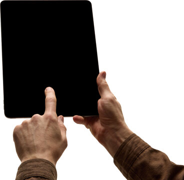 Male hands holding tablet with black screen, with one finger touching screen on transparent background, close up. Concept of technology, digital, communication, app.