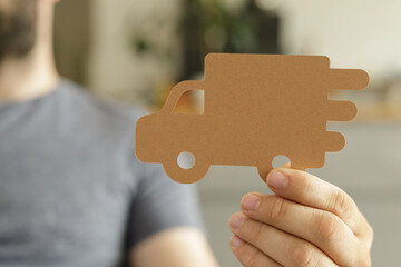 Hand holding cardboard truck,fast shipping, delivery concept.  Perfect for logistics, ecommerce...