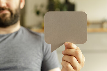 Stock photo of a man holding a blank speech bubble. Perfect for communication, feedback, and...
